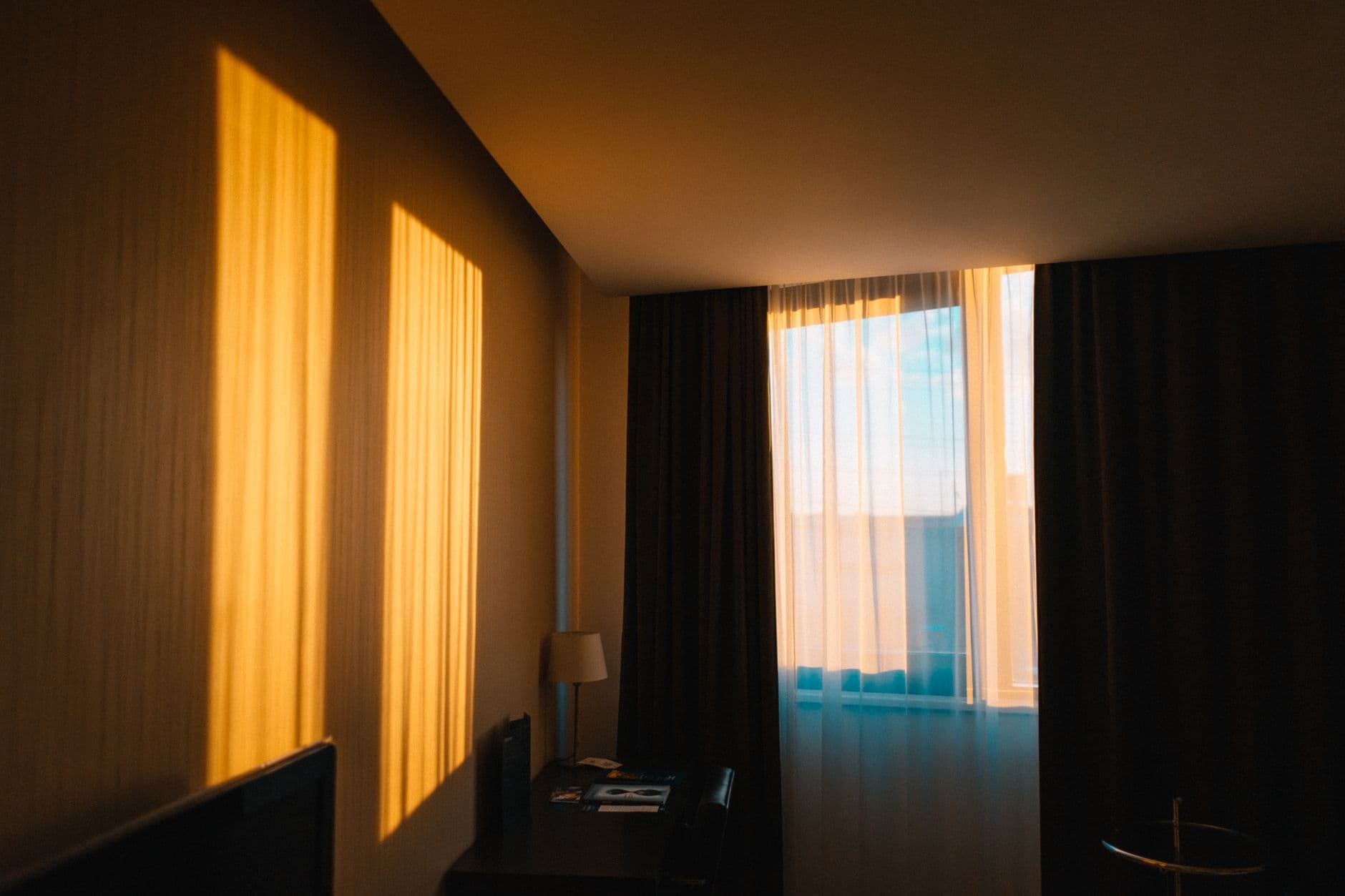 A calm room filled with warm morning light through the curtains